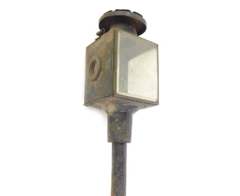 A late 19thC black tin carriage lantern,  with glass panelling, 38cm high. 