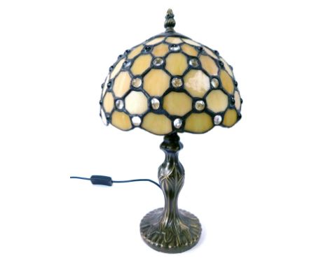 A Tiffany style table lamp, with a pearlescent glass shade, on a bronzed lamp base, 40cm high.WARNING! This lot contains unte