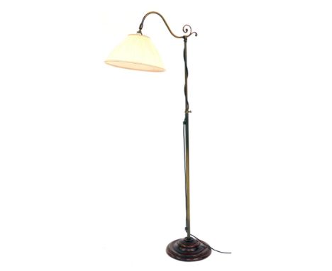 A 20thC brushed brass table lamp, with fabric shade raised on a circular wooden stepped base, 141cm high. 