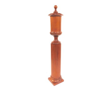 A 20thC mahogany pedestal urn, the cylindrical urn with lid, on a cylindrical fluted column on square base, 190cm high. (AF)