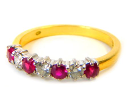 An 18ct gold, ruby and diamond half hoop dress ring, set with four round brilliant cut rubies and three round brilliant cut d