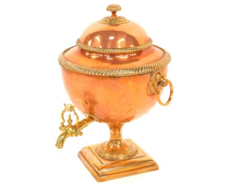 A Victorian brass and copper tea urn, globular form with a brass reeded border and ring handles, on square stepped base, 45cm