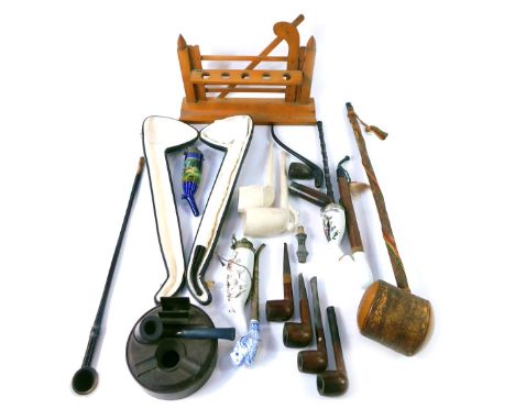 A group of pipes, wooden, porcelain, to include a rosewood pipe, novelty German porcelain and wooden pipe, pipe stand, etc. (