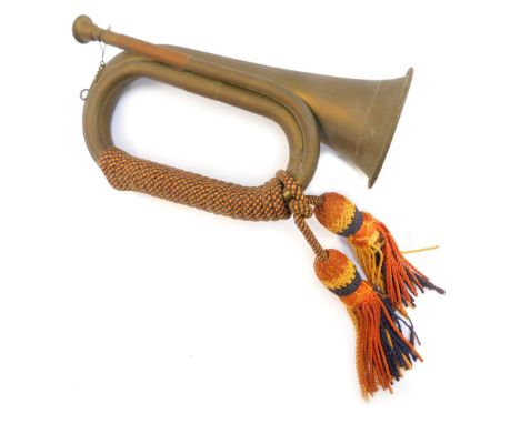 A copper and brass bugle, with orange, yellow and blue rope work frogging, 29cm long. 