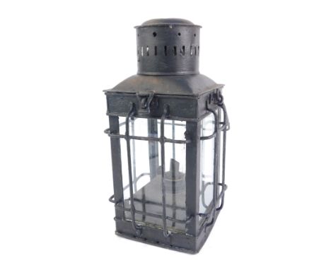A 20thC lantern, overpainted in black, of square set form with caged detail over panelling, 34cm high. 
