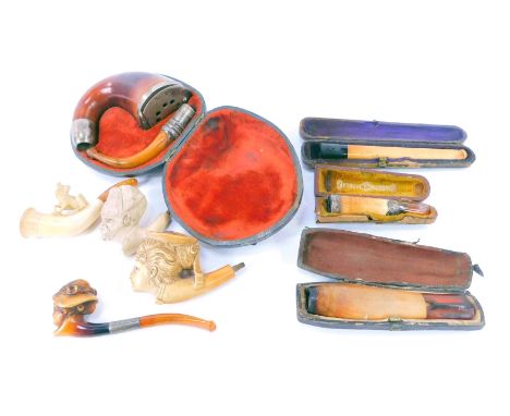A group of smoking related items, to include meerschaum pipes, amber cheroots, a partial pipe decorated with a figure of a do