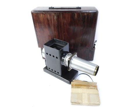 An early 20thC projector, with reel, in stained pine case, the projector 20cm high. 