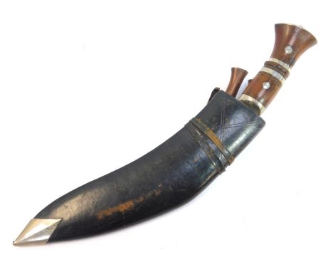 A Nepalese or Indian Kukri, with wooden handle, curved steel blade, together with the karda and chakmak knives, in black leat