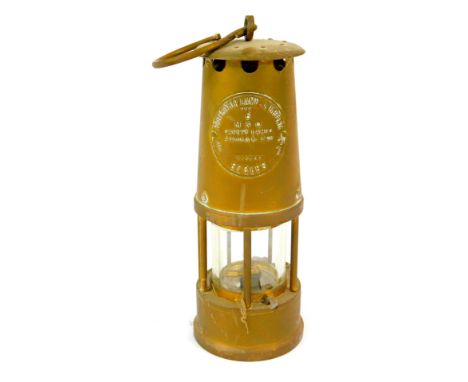 A Protector Lamp and Lighting Company Eccles brass miner's lamp, type 6, with swing handle, 25cm high. 