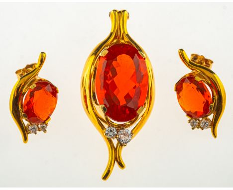 A fire opal and diamond pendant with matching earrings, the pendant/necklace enhancer is claw set with an oval-cut fire opal,