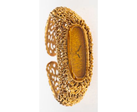 A 9ct gold bracelet watch of tree bark form the oval dial with black baton numeral and bevelled orange glass, having a hinged