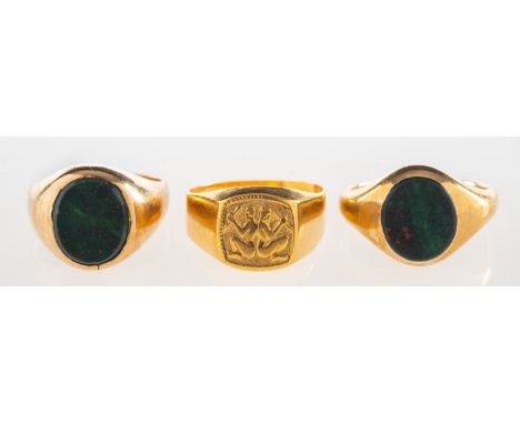 A group of three rings, including two 9ct gold bloodstone signet rings, both UK hallmark, sizes I1/2 and L, total gross weigh