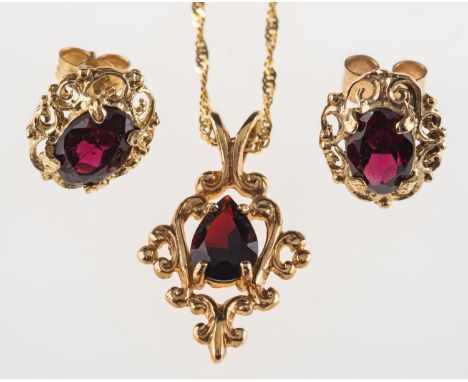 A garnet pendant with chain and a pair of garnet earrings, the pendant of ornate openwork design and set with a pear-shaped g