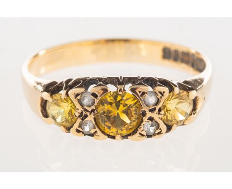 A 9ct gold ring, set with yellow and white paste stones, UK hallmark, size N1/2, 2.1grams.