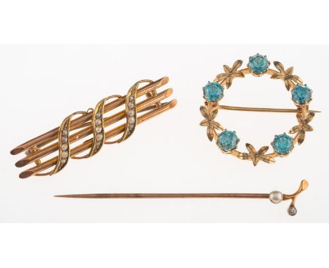 Two brooches and a stick pin, including a circular floral brooch set with five circular-cut blue zircons, marked 9ct, diamete