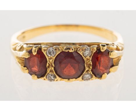 An antique garnet and diamond ring, set with a circular-cut garnet and two oval-cut garnets and three single-cut diamonds and