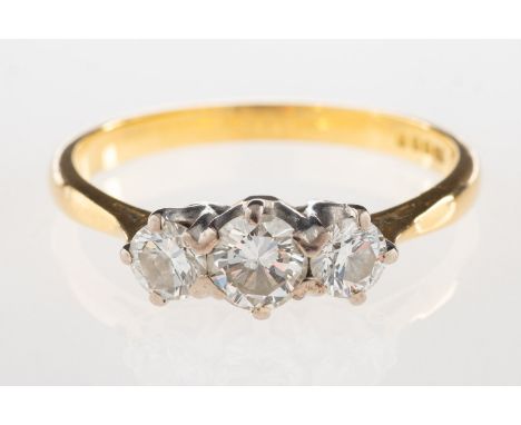 An 18ct gold three stone diamond ring, set with three graduated brilliant-cut diamonds, diamonds approx. 0.50 carat total, UK