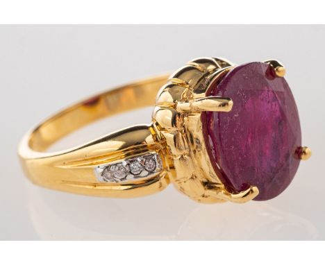 An 18ct gold ruby and diamond ring, claw set with an oval-cut ruby, approx. 4.50 carats, with four brilliant-cut diamonds set