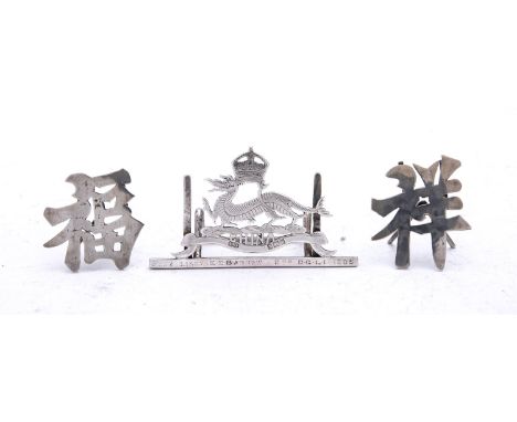 An Edward VII silver menu card holder by William Hutchinson, Birmingham 1902, in the form of a dragon with crown above and Ch