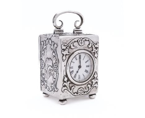 An Edward VII silver carriage clock by William Comyns & Sons, London 1900, the case embossed with profuse foliate scroll and 