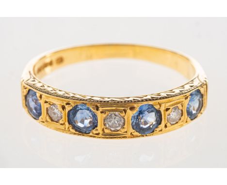 An 18ct gold sapphire and diamond eternity ring, set with four circular-cut sapphires, interspaced by three brilliant-cut dia