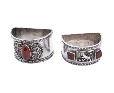 Two Arts and Crafts silver and gemset D shaped napkin rings by Amy Sandheim, London, one with applied Gothic decoration and r
