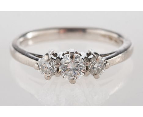 A platinum three stone ring, claw set with three brilliant-cut diamonds, diamonds approx. 0.50 carat total, UK import mark, s