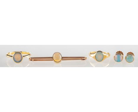 A group of opal set jewellery, including a signet style ring set with an oval opal cabochon, marked 18, size I1/2, 2.5grams; 
