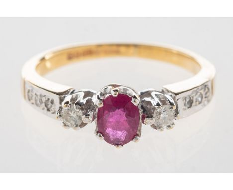 A 9ct gold ruby and diamond ring, set to the centre with an oval-cut ruby and a brilliant-cut diamond set each side, with thr