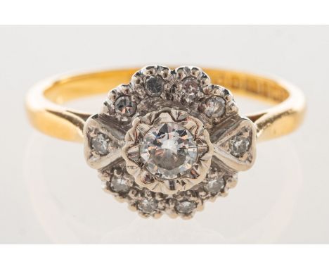 An 18ct gold diamond daisy ring, of flowerhead form and set with a central brilliant-cut diamond, diamond approx. 0.15 carat,
