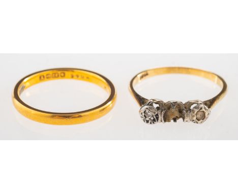 A 22ct gold wedding band and another ring, a 22ct gold wedding band, UK hallmark, size J1/2, 2.8grams; and a three stone ring