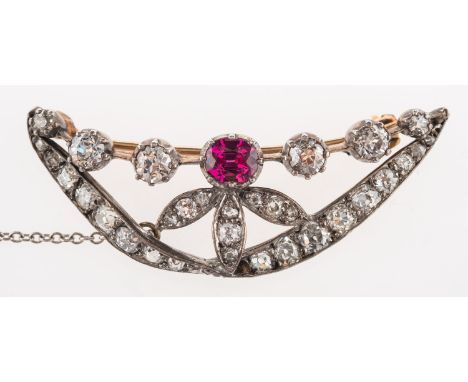 A Victorian ruby & diamond brooch, an openwork brooch of leaf and twisted ribbon form set with an oval-cut ruby and a mixture