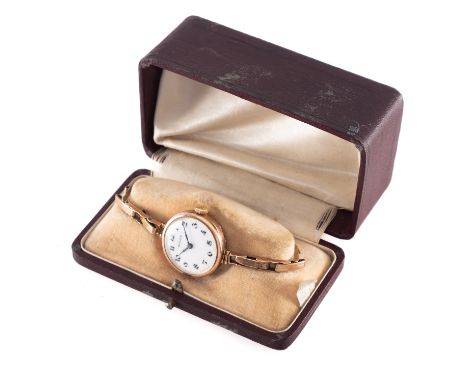 Rolex, a vintage ladies gold wristwatch the round white dial having black Arabic numerals, blued steel hands and signed Rolex