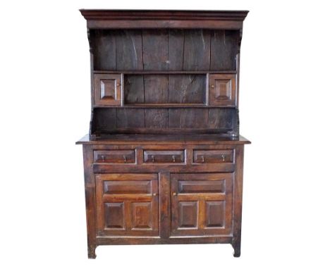 An 18th century oak high dresser, North Wales, possibly Denbighshire, the moulded cornice over two open shelves and two singl