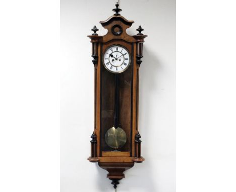 A late 19th century walnut and ebonised twin weight driven Vienna style wall clock, the 6½ inch white enamel dial with ring o