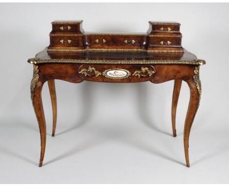 A 19th century French figured walnut bureau plat the serpentine top with two short and one central long drawer to the back, o