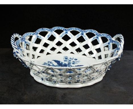 A Caughley oval basket, circa 1776-80, the diamond pierced tapering sides with flower head applications, set within rope twis