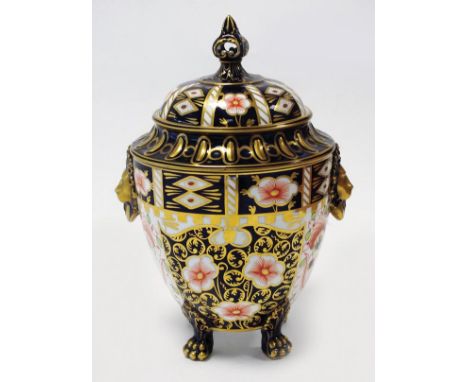A Royal Crown Derby Imari vase and cover with a crown finial, dated 1914, with a pair of opposing lion shaped handles and fou