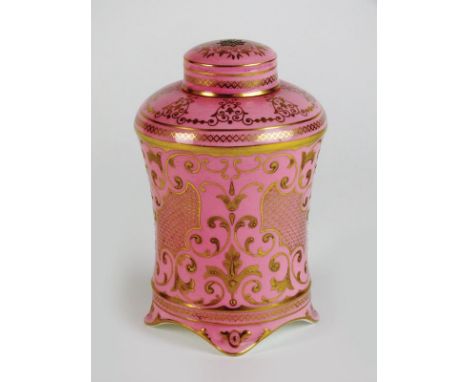 A Coalport tea caddy, early 20th century, with cover and inner two divisional liner, the pink ground body with low gilt relie