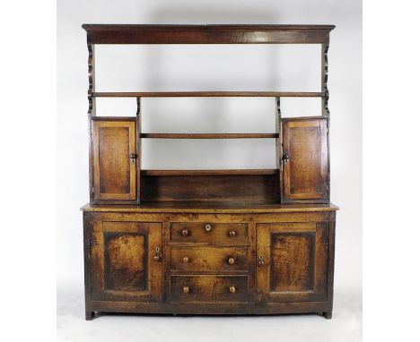 An early 19th century oak high dresser, Shropshire, the open rack with a long shelf over two short central shelves flanked by