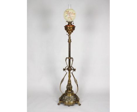 A Victorian cast brass telescopic lamp standard with copper reservoir and mottled shade with blossom decoration on a three fo