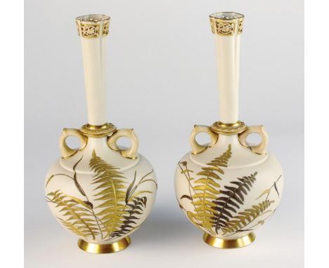 A pair of Royal Worcester blush ivory vases, dated 1888, of twin handled form with opposing loop handles and slender neck wit