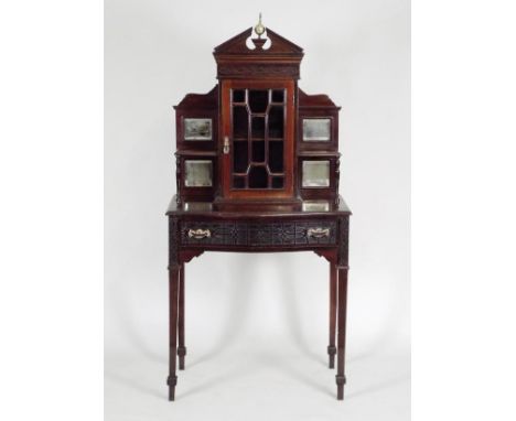 an early 20th century mahogany Chippendale style side cabinet, the centre cabinet with astragal glazed door and pointed arche