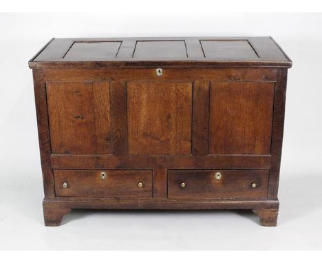 A George III oak mule chest, the three panel top over a plain three panel front with two drawers below raised on plain bracke