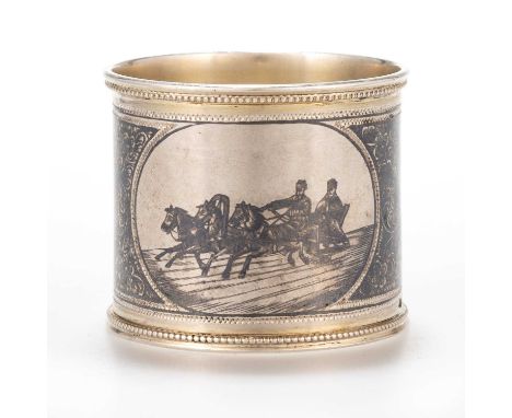 A RUSSIAN SILVER AND NIELLO NAPKIN RING c.1899-1908, circular, decorated with figures in a troika. 4.5cm diameterIn generally