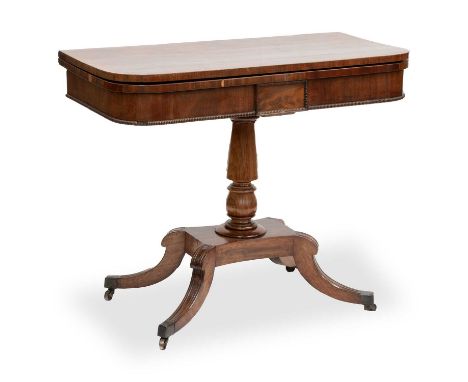 A REGENCY MAHOGANY FOLDOVER CARD TABLE the crossbanded top with rounded corners, raised on a tapering stem issuing from a pla