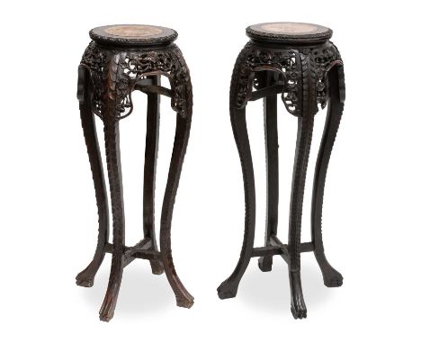 A PAIR OF CHINESE MARBLE-INSET HARDWOOD PLANTSTANDS, CIRCA 1900 each circular top with a conforming marble inset and a leaf-c