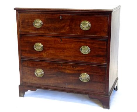 A 19thC mahogany chest of drawers, the top with a moulded edge above three drawers each with oval brass handles, cast with ne