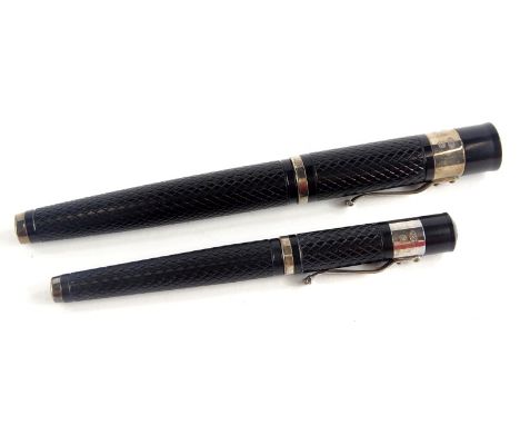 Two Yard-O-Led black and silver mountain fountain pens, of differing sizes.