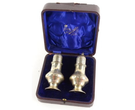 A pair of Edwardian silver sugar castors, each of baluster form, the lid with Howard decoration, London 1905, (AF).